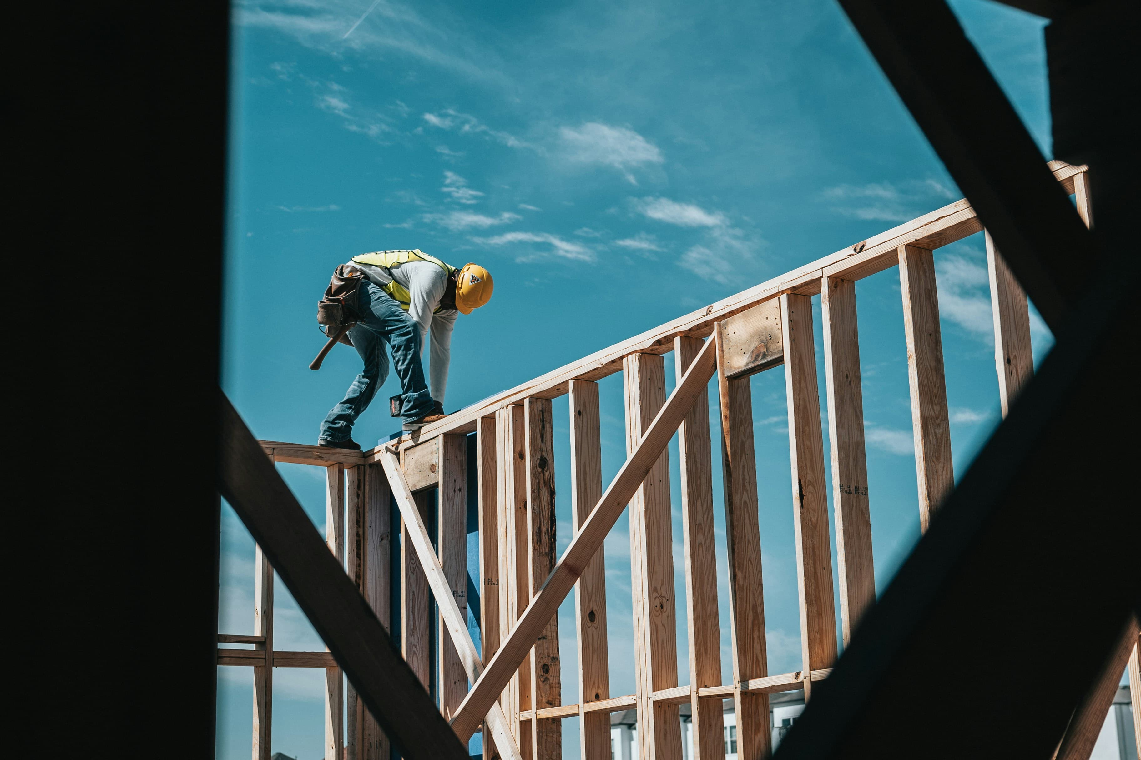 Worker installing framing on an active construction site
